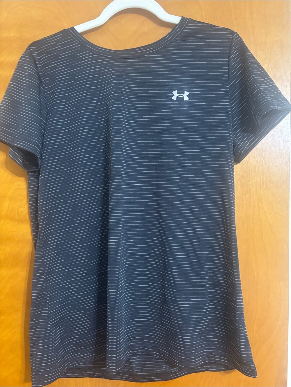 Like new, size Large Under Armour Black Tee with Thin Gray Stripes